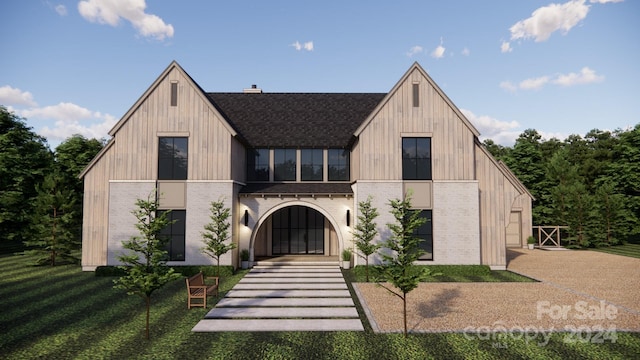 view of front facade with a balcony and a front lawn