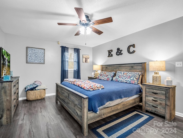 bedroom with dark hardwood / wood-style floors, ceiling fan, and a textured ceiling