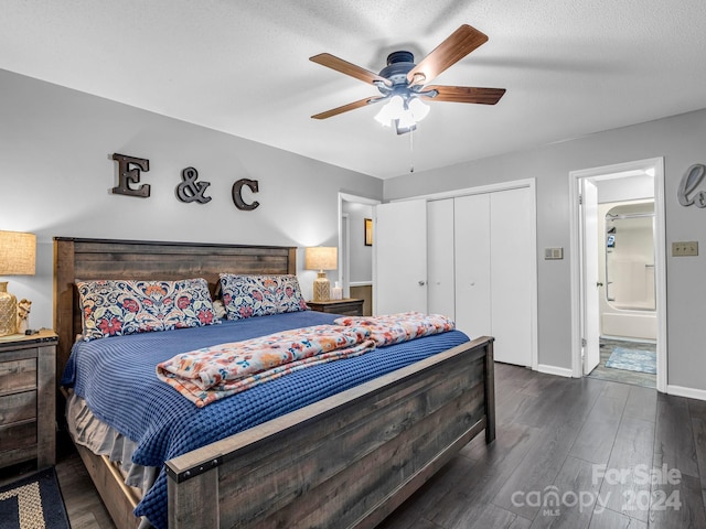 bedroom with ceiling fan, dark wood-type flooring, ensuite bathroom, a textured ceiling, and a closet