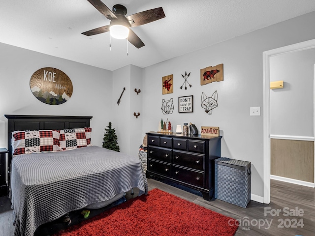 bedroom featuring ceiling fan and dark wood-type flooring