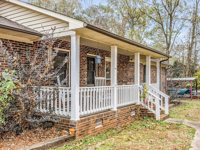 view of side of property featuring covered porch