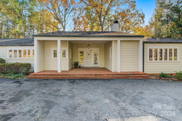 view of front facade with french doors and a porch