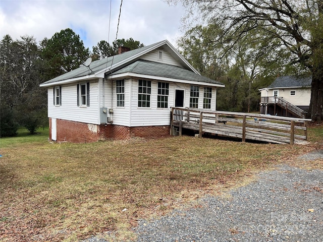 210 Lincoln St, Albemarle, NC 28001 - view of front of house with a deck, a chimney, a front lawn, and a shingled roof