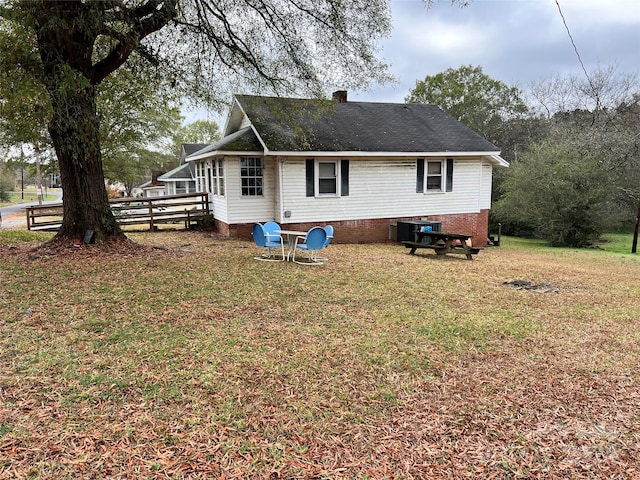 back of property with a lawn