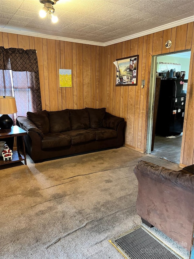 living room featuring wood walls, carpet flooring, and ornamental molding