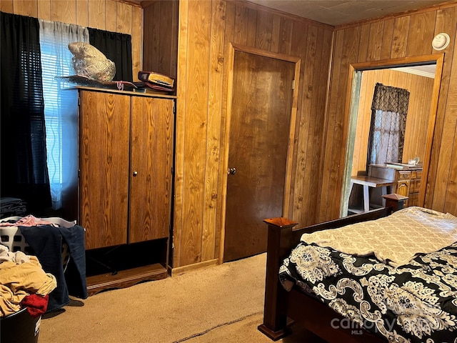 carpeted bedroom with wooden walls and a closet