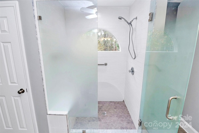 bathroom with a shower with door