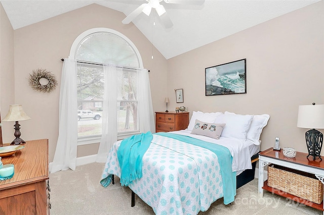 carpeted bedroom featuring ceiling fan and vaulted ceiling