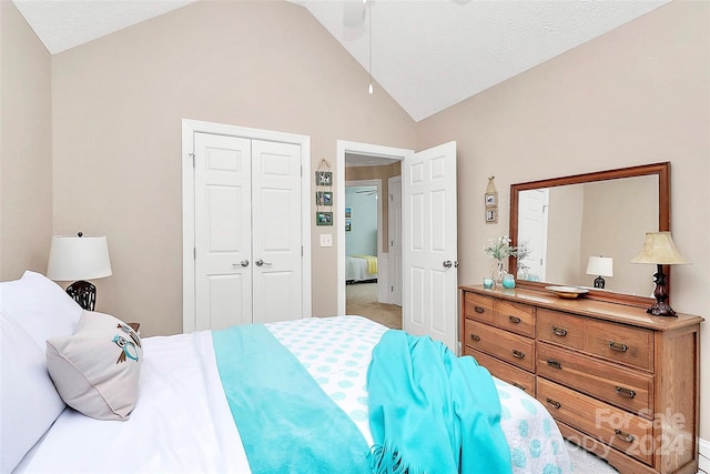 bedroom with a textured ceiling, light colored carpet, a closet, and ceiling fan