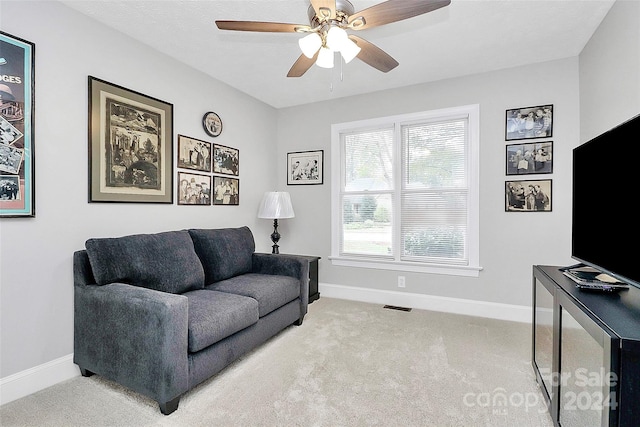 living room featuring light carpet and ceiling fan