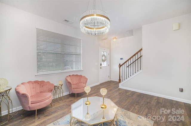 living room featuring an inviting chandelier and dark wood-type flooring