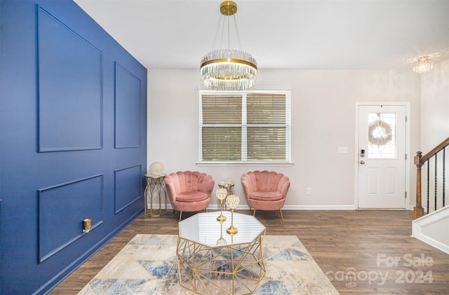 foyer entrance with a notable chandelier and dark hardwood / wood-style flooring