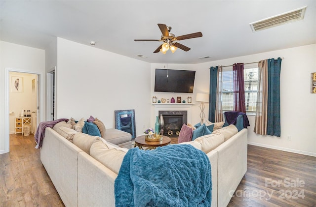 living room featuring hardwood / wood-style floors and ceiling fan