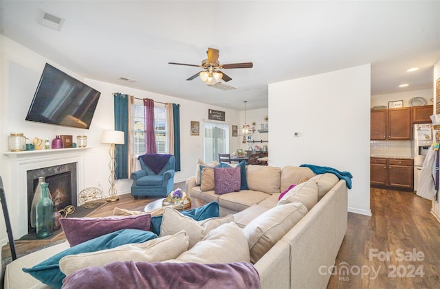 living room featuring a fireplace, dark hardwood / wood-style floors, and ceiling fan