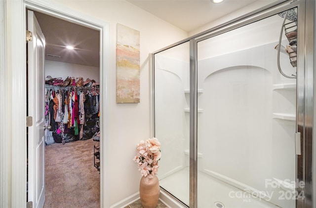 bathroom with a shower with shower door