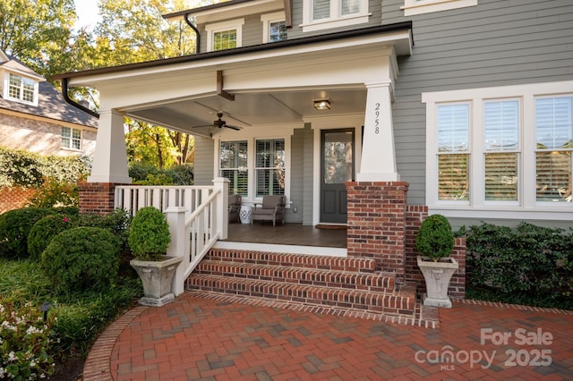 doorway to property with ceiling fan and a porch