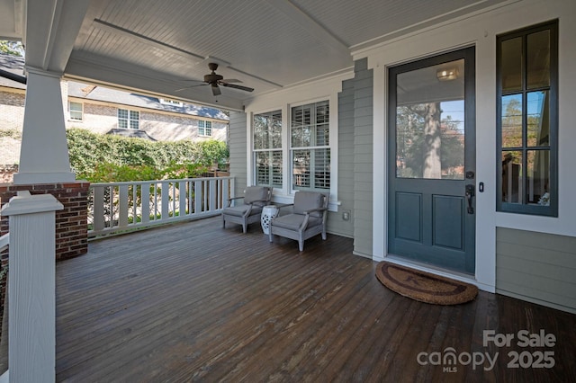 wooden deck featuring ceiling fan and covered porch