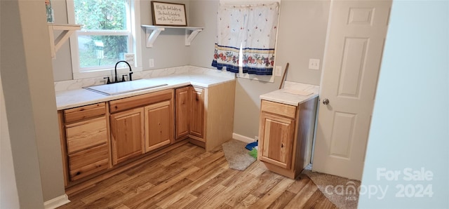 interior space with sink and light wood-type flooring