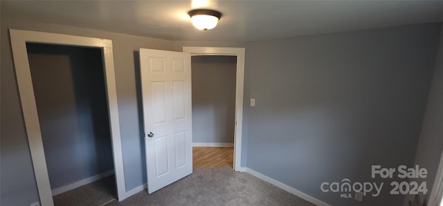 unfurnished bedroom featuring a closet and carpet floors