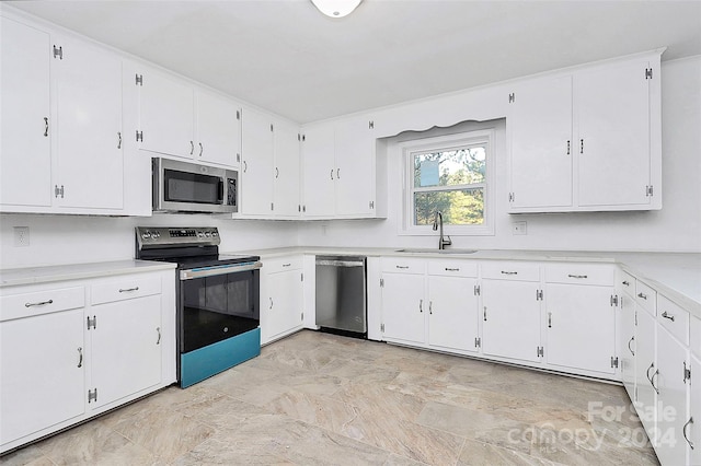 kitchen with white cabinets, stainless steel appliances, and sink