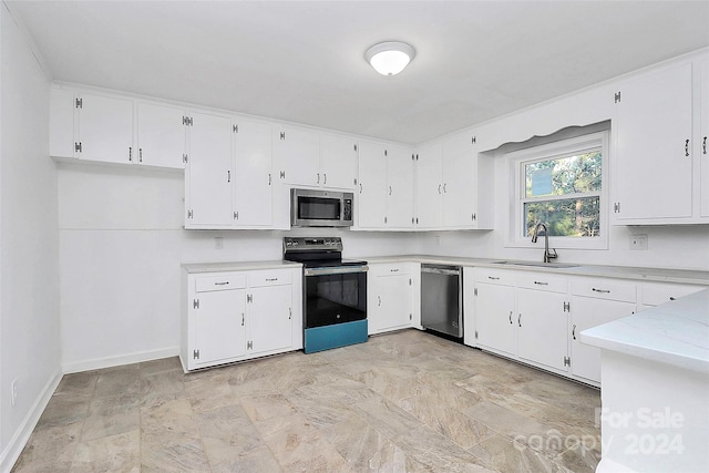 kitchen with white cabinets, sink, and appliances with stainless steel finishes