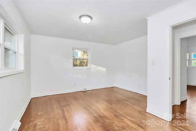 spare room with wood-type flooring