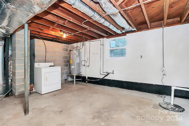 basement featuring electric water heater and washer / dryer