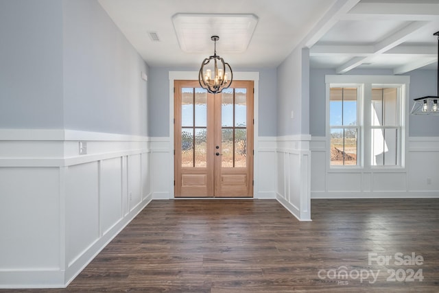 doorway featuring french doors, dark wood-type flooring, a chandelier, coffered ceiling, and beamed ceiling