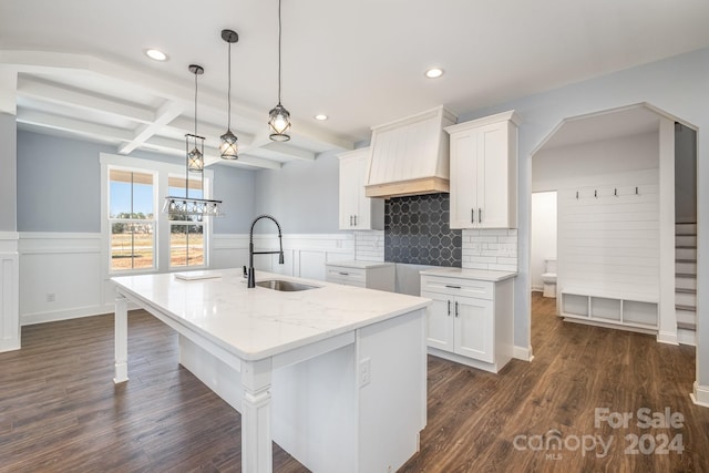 kitchen with white cabinets, dark hardwood / wood-style flooring, beamed ceiling, and sink