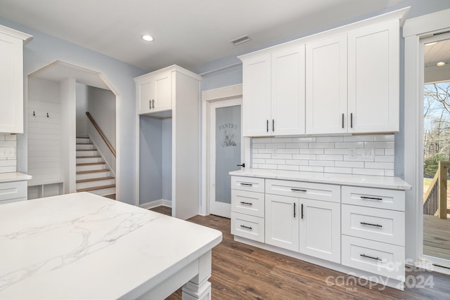 kitchen featuring dark hardwood / wood-style flooring, tasteful backsplash, and white cabinets