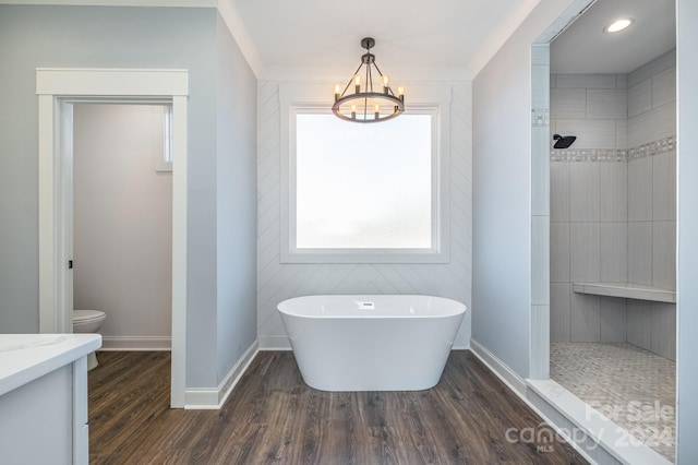 bathroom with toilet, hardwood / wood-style floors, ornamental molding, and separate shower and tub