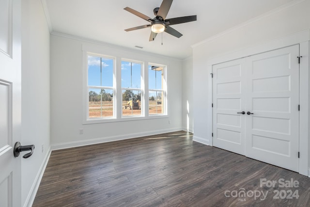 unfurnished bedroom with a closet, crown molding, ceiling fan, and dark hardwood / wood-style floors