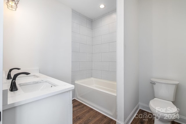 full bathroom featuring toilet, vanity, wood-type flooring, and  shower combination