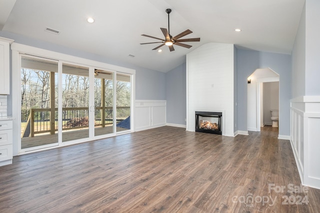 unfurnished living room with ceiling fan, a wealth of natural light, and dark hardwood / wood-style floors