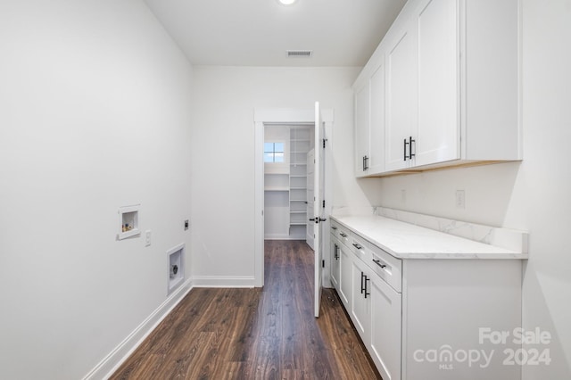 laundry room featuring hookup for an electric dryer, dark hardwood / wood-style flooring, washer hookup, and cabinets