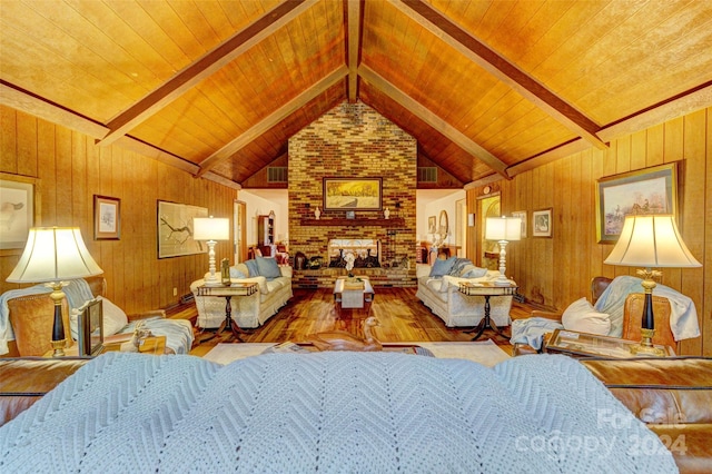 living room with wood walls, hardwood / wood-style flooring, wood ceiling, and lofted ceiling with beams