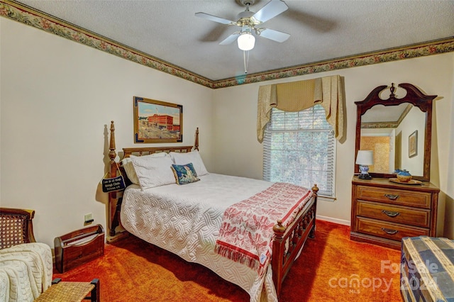 bedroom with ceiling fan, a textured ceiling, dark colored carpet, and ornamental molding