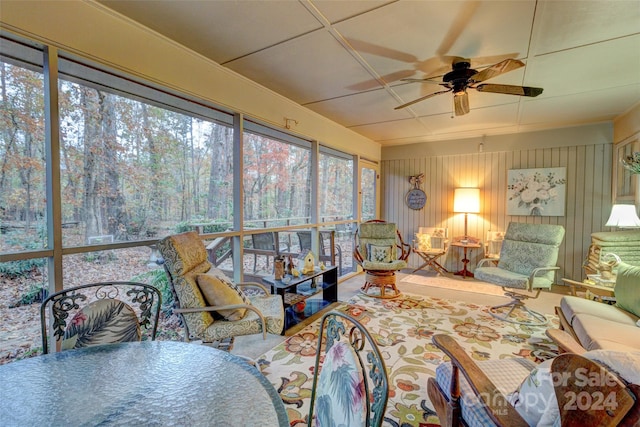 sunroom / solarium featuring ceiling fan