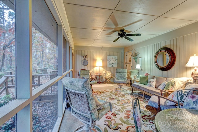 sunroom / solarium with a healthy amount of sunlight and ceiling fan