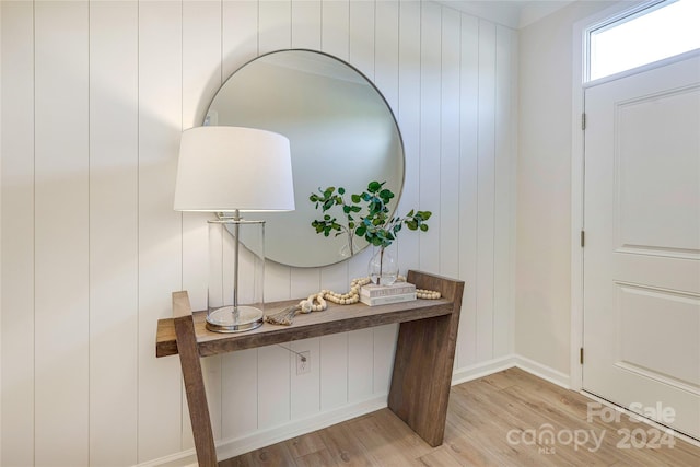 foyer featuring light hardwood / wood-style flooring and wood walls