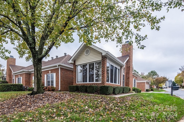 view of side of property with a lawn