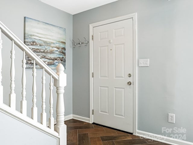 foyer entrance with dark parquet floors