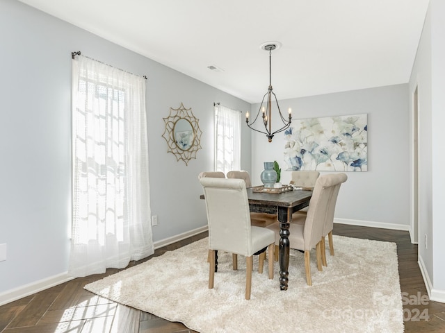 dining space featuring a chandelier, dark hardwood / wood-style floors, and plenty of natural light