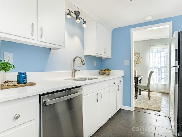 8002 Regent Park Ln, Charlotte, NC 28210 - kitchen with stainless steel appliances, white cabinetry, light countertops, and dark tile patterned flooring