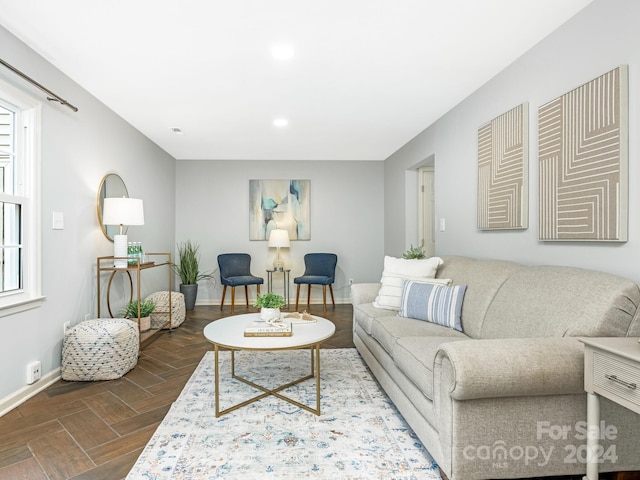 living room with dark parquet flooring and plenty of natural light