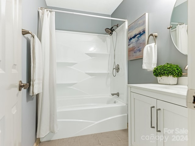 bathroom featuring tile patterned flooring, vanity, and shower / tub combo with curtain