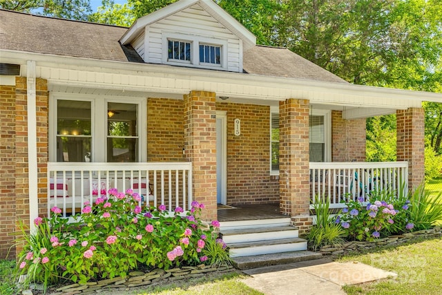 view of exterior entry with a porch