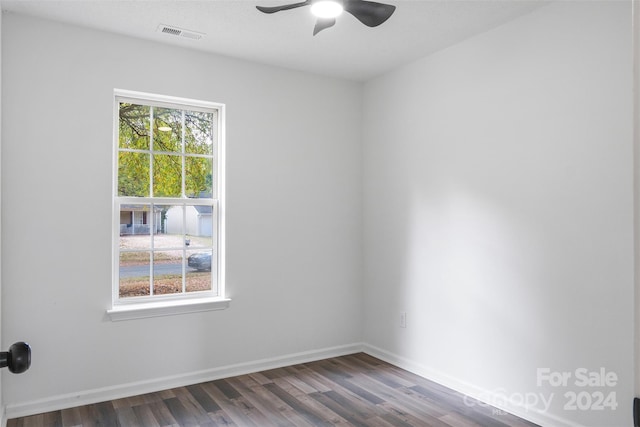 empty room featuring dark hardwood / wood-style flooring and ceiling fan