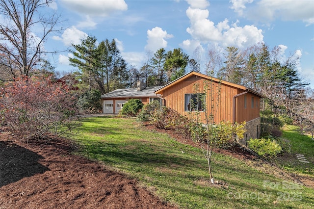 view of side of home featuring a yard