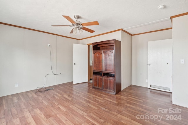 unfurnished bedroom with ceiling fan, wood-type flooring, and ornamental molding